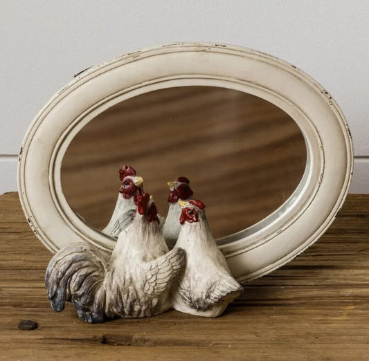 Hens peeking in mirror